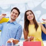 Happy young couple holding shopping bag
